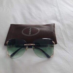 Green y2k sunglasses with a brown leather case